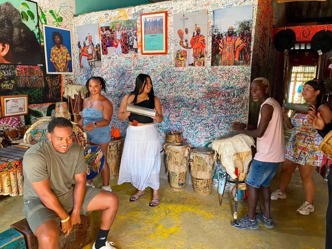 Guests playing traditional drums during a cultural tour in San Basilio de Palenque
